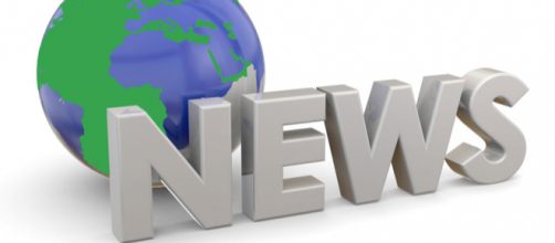 A sign stating "News" in front of a model of the world representing "World News."