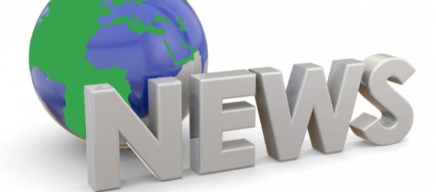 A sign stating "News" in front of a model of the world representing "World News." A sign stating "News" in front of a model of the world representing "World News."