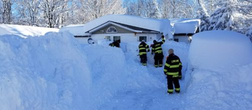 Rescuers in Lorraine, New York clear snow that blocked a residence. [image via Facebook/Lorraine Volunteer Fire Company]