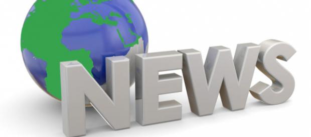 A sign stating "News" in front of a model of the world representing "World News." A sign stating "News" in front of a model of the world representing "World News."