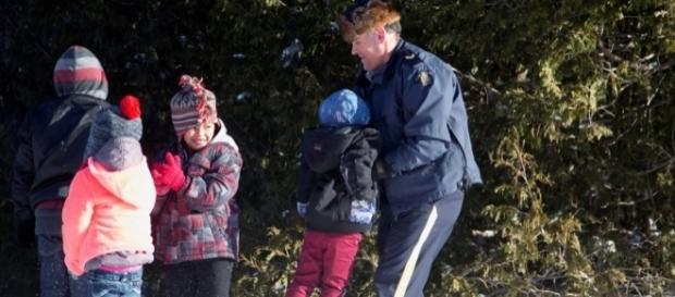 RCMP assisting family from Sudan crossing US - Canada Border from Champlain NY (credit Reuters Christine Muschi) RCMP assisting family from Sudan crossing US - Canada Border from Champlain NY (credit Reuters Christine Muschi)