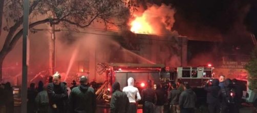 Survivors of the Dec. 2 Ghost Ship fire in Oakland watch from street as firefighters battle blaze that killed 36. (Photo: sfgate.com)
