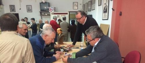 Antonio Romero firmando uno de sus libros a un vecino de Arriate.