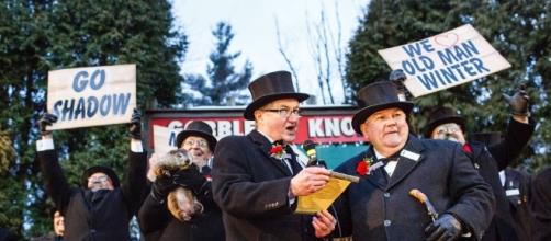 Weather forecaster Punxsutawney Phil hangs at back as his prediction is read. / Photo from 'Penn Live' - pennlive.com