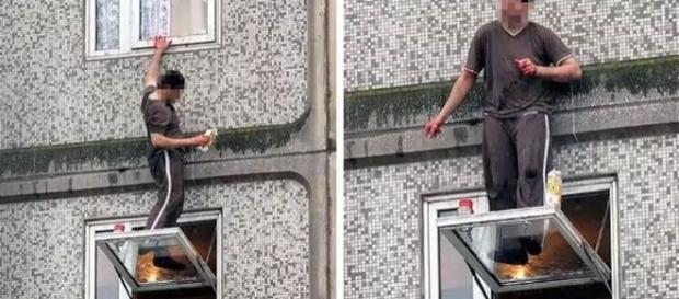 Homem limpando a janela sem proteção nenhuma Homem limpando a janela sem proteção nenhuma