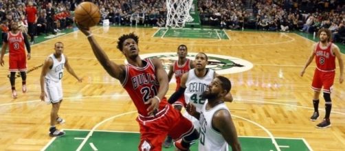Bulls forward Jimmy Butler drives against the Celtics defense (via oskeimsportspicks.com)