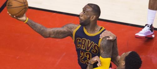 LeBron goes up strong to score with DeMar DeRozan pulling down on ... - usatoday.com