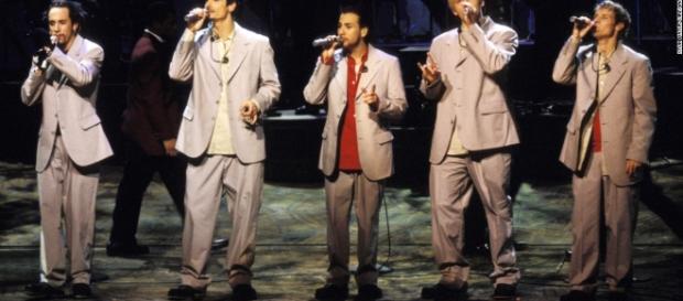 The Backstreet Boys are on the stage together. The Backstreet Boys are on the stage together.