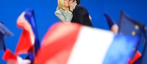French president Emmanuel Macron kisses his wife Brigitte Trogneux. CREDIT: http://www.harpersbazaar.com