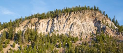 Volcanic activity spotted at Yellowstone. Tuff Cliff reveals an ash flow welded into rock. [Image via NPS/Neal Herbert]