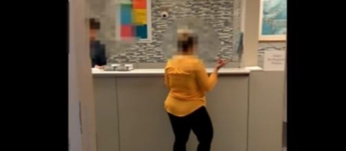 The woman in yellow is the subject of a viral video after she demanded for a white doctor to treat her ill son - YouTube/CBS News