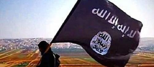 ISIS flag credits:wikipedia https://en.wikipedia.org/wiki/Military_activity_of_ISIL#/media/File:%C4%B0D_bayra%C4%9F%C4%B1_ile_bir_militan.jpg