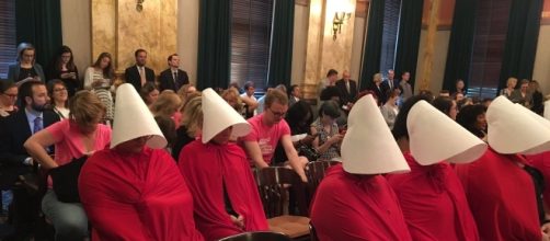 A group of women stage a silent protest against Ohio Senate bill 145 dressed as characters from "The Handmaid's Tale."