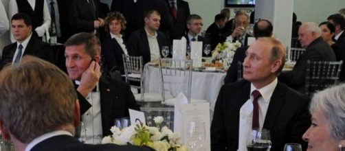 Vladimir Putin sat beside Michael Flynn at a dinner in Russia in 2015. - rferl.org