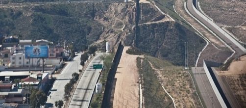 Border fence near San Diego (credit - Josh Denmark, wikimediacommons)