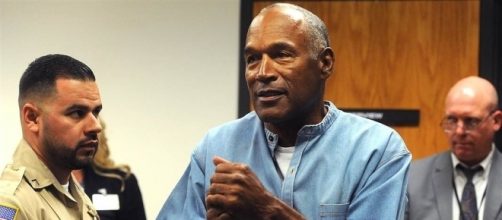 O.J. Simpson clasps his hands in joy after being granted parole from Las Vegas robbery case. (Image Credit: nbcnews.com)