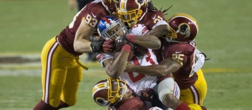 Rashad Jennings powering through four Washington defensemen. (Via Flickr Keith Allison)