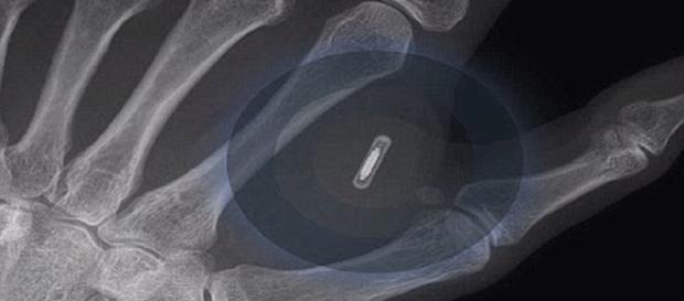 The microchip is implanted between the thumb and the forefinger. Image credit - SignsofThyComing/ouTube. The microchip is implanted between the thumb and the forefinger. Image credit - SignsofThyComing/ouTube.