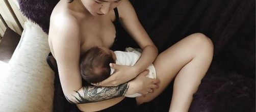 Aliya Shagieva, 20, breastfeeding her one moth baby dressed on her underwear.
