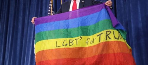 Donald Trump looks slightly awkward as he holds up LGBT rainbow ... - thesun.co.uk