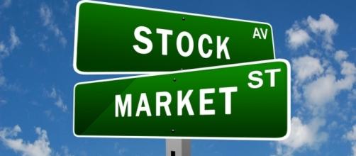 Start investing in stocks right now. [Image via Flickr/Stock Market]