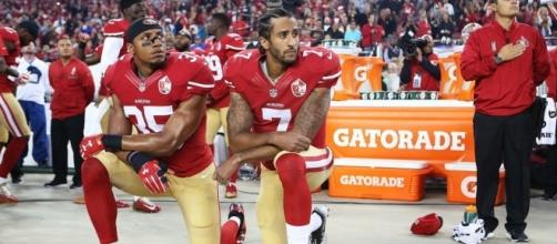 Colin Kaepernick takes a knee during the National Anthemn (Video screen shot You Tube)