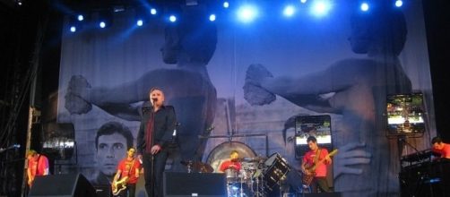 Morrissey on stage with band - photo by Alexander via Wikimedia Commons.