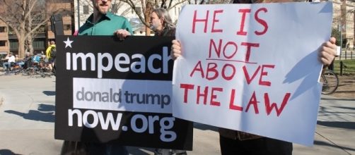 Anti-Trump protesters calling for impeachment. / [Image by Elvert Barnes via Flickr, CC BY-SA 2.0]