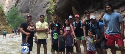 Jhonatan Gonzalez and his family formed a human chain to help hikers across the flash-flooded river [Image: YouTube/KHON2 News]