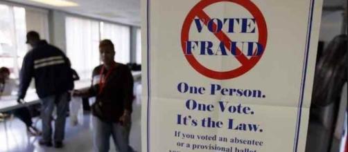 Sign warning against voter fraud. (YouTube snipped)