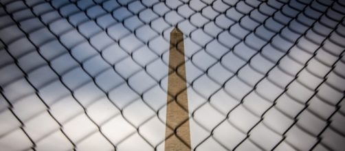 Washington Monument behind a fence in D.C. / [Image by M01229 via Flickr, CC By 2.0]