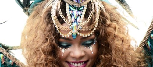 Rihanna in her aqua colored hair and mini shorts in Barbados - Screenshot via RihannaVEVO – YouTube
