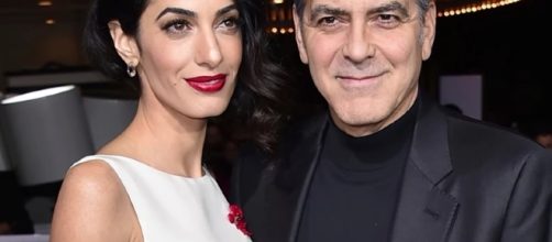 George and Amal spend time with Amal's mother through a dinner. Image via YouTube/Wochit