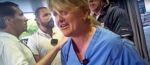 A Salt Lake police officer is under criminal investigation for wrongfully arresting a nurse [Image: YouTube/Deseret News]