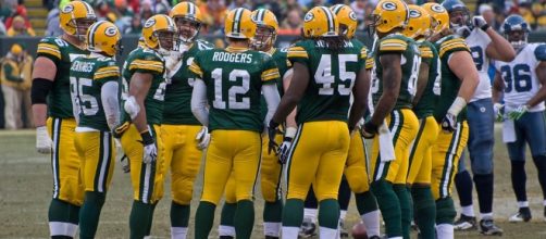 Green Bay Packers huddle. [Image by Mike Morbeck|Wikimedia Commons]