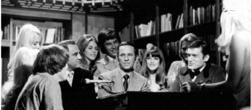Photo of Don Adams (center) Barbi Benton and Hugh Hefner from the television program Playboy After Dark - Image CCo Public Domain | Wikimedia
