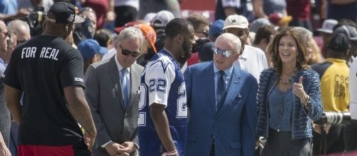 Jerry Jones speaking with player John Wall, by Keith Allison
