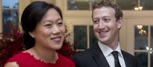 Mark Zuckerberg cuddles newborn daughter, August. YouTube/Bloomberg