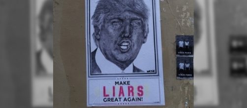 Trump poster in Paris / [Image by Guilhem Vellut via Flickr, CC BY 2.0]