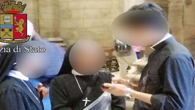 Il giovane mentre conversa con due suore all'interno del Duomo