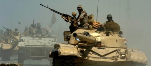 Iraqi T-72 tanks pass through a checkpoint in Mushahada, Iraq | Photo from Michael Larson via Wikipedia Commons.