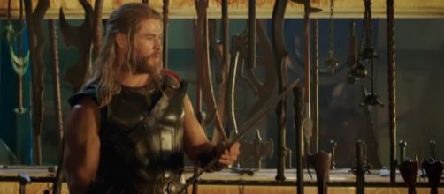 Chris Hemsworth playing with props on the set of 'Thor'. [Image via Looper/YouTube screencap]