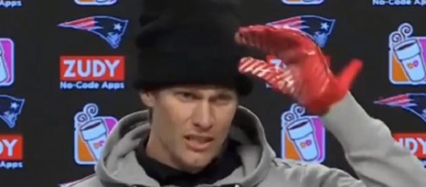 Tom Brady was wearing red gloves on both hands during Friday’s press conference (Image Credit: The Wildcard/YouTube) Tom Brady was wearing red gloves on both hands during Friday’s press conference (Image Credit: The Wildcard/YouTube)