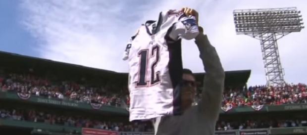 Tom Brady shows the stolen jersey to Boston Red Sox fans after it was recovered (Image Credit: MLB/YouTube) Tom Brady shows the stolen jersey to Boston Red Sox fans after it was recovered (Image Credit: MLB/YouTube)