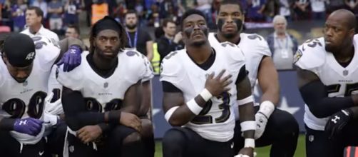 Baltimore Ravens players kneeling before a game, against the Jaguars, in protest. [image credit: CNN/ Youtube screenshot]