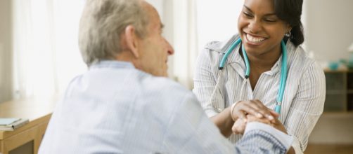 Home healthcare worker checks elderly patient [image credit: Myfuture/Flickr]