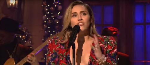 Miley Cyrus closed her SNL performance with wide-hearted wishes and 'Merry Christmas.' - [SNL / YouTube screencap]