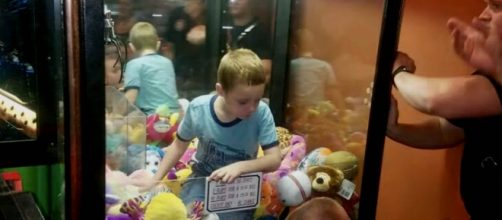 A young boy was so determined to get the toy he wanted, he climbed inside the machine [Image credit: CBS News/YouTube]