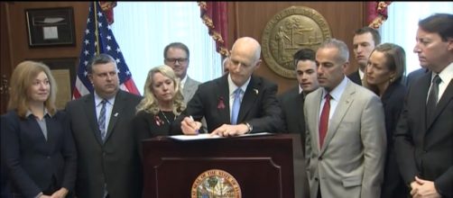 Governor Rick Scott signs new bill-youtube/PBS NewsHour