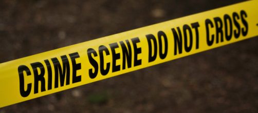 Yellow crime scene tape at an accident site (Image via Kat Wilcox - Pexels)